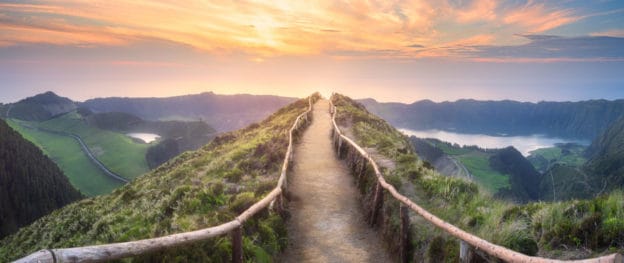 A serene path winding up a mountain at sunset, symbolizing hope and healing.